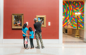 family looking at art in a museum