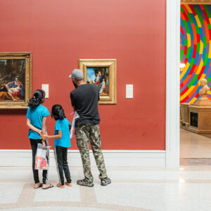 family looking at art in a museum