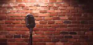 Stand up comedy stage microphone background brick wall.