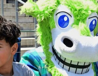 Hartford Yard Goats mascot with young fan