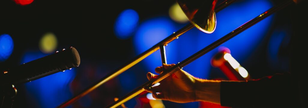 Closeup shot of a person playing the trombone at a concert
