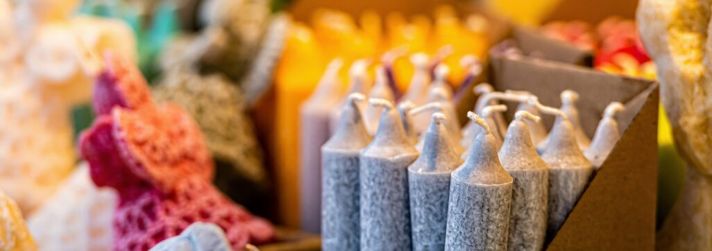 different colors and shapes of candles on the Christmas market, close-up, selective focus