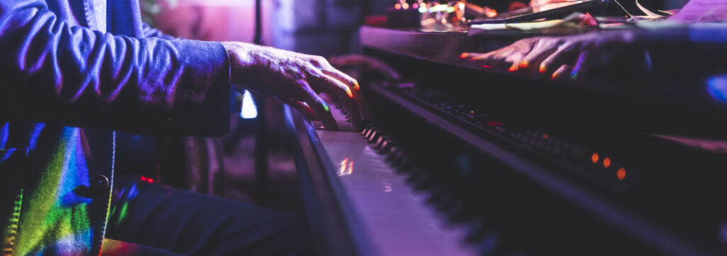 close up of man playing piano