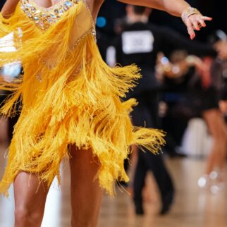 female dancer in yellow dress in dance competition