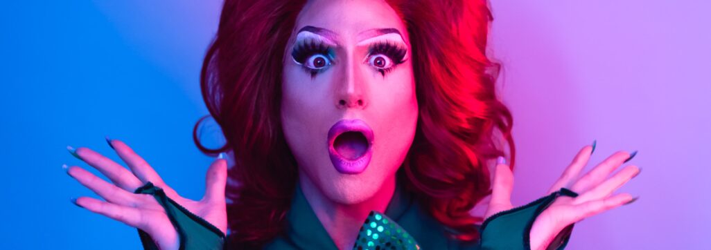 Happy drag queen having fun acting surprised in front of camera - LGBTQ concept