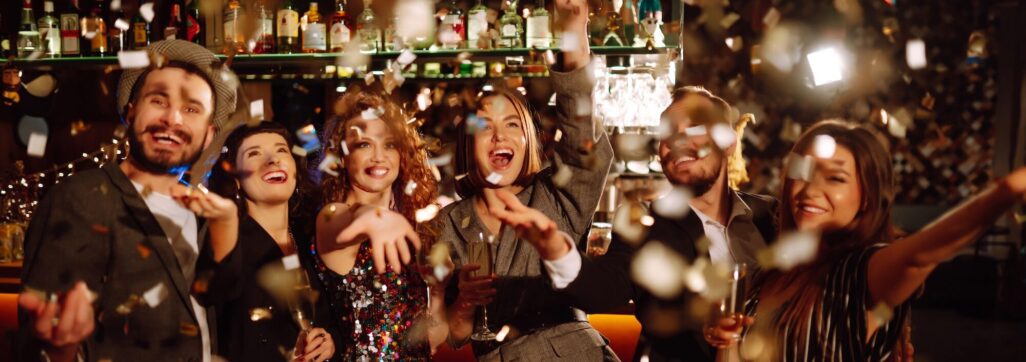 Happy friends throwing confetti and jumping while enjoying party Confetti is fun. Party, celebration