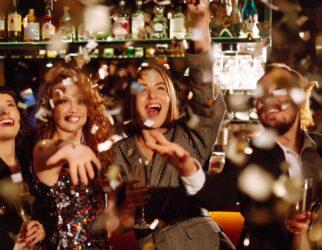 Happy friends throwing confetti and jumping while enjoying party Confetti is fun. Party, celebration