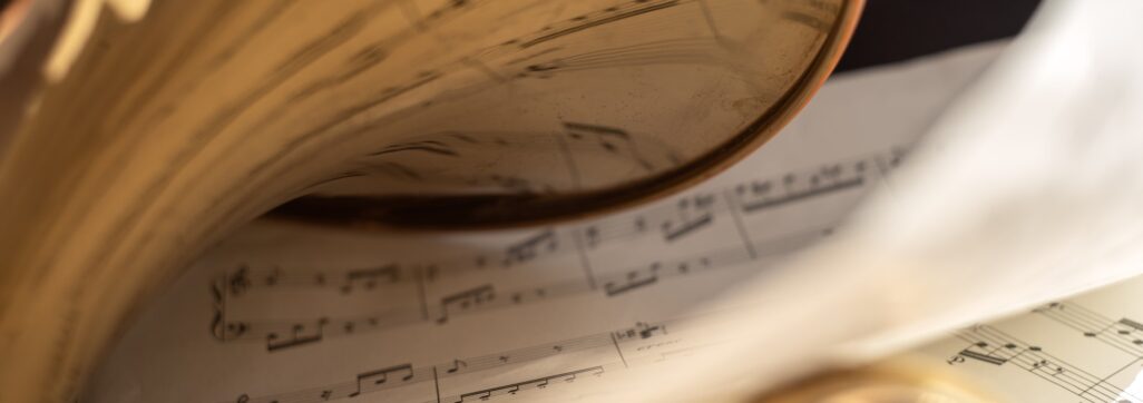Music notes reflected in part of old golden french horn