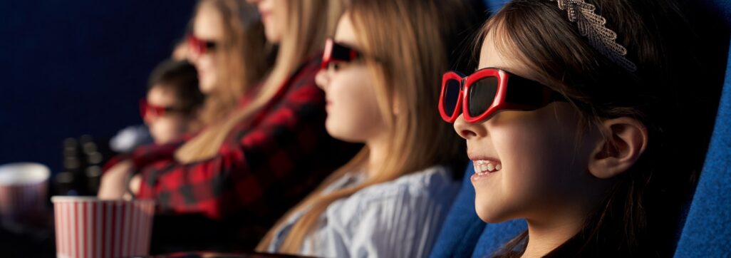 People, kids watchng movie in 3d glasses in cinema
