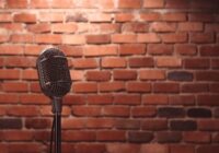 Stand up comedy stage microphone background brick wall.
