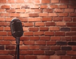 Stand up comedy stage microphone background brick wall.