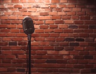 Stand up comedy stage microphone background brick wall.