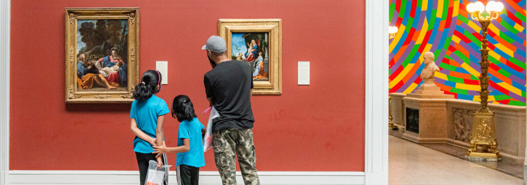 family looking at art in a museum