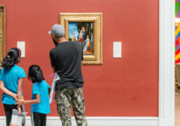 family looking at art in a museum