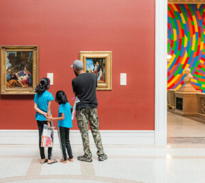 family looking at art in a museum
