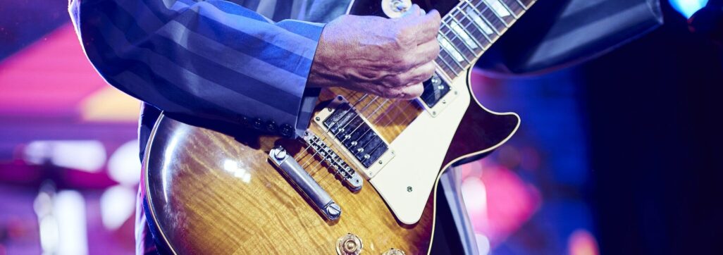 unrecognizable man playing the electric guitar