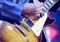 unrecognizable man playing the electric guitar