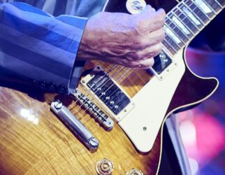 unrecognizable man playing the electric guitar